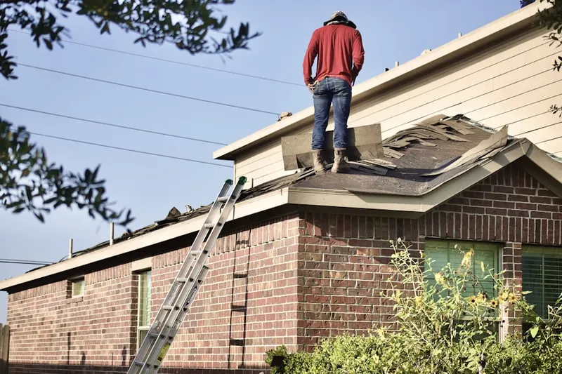 Professional roofer working on a residential roof in Biola